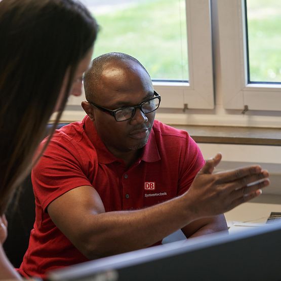 A man and a woman look at measurement results on a screen