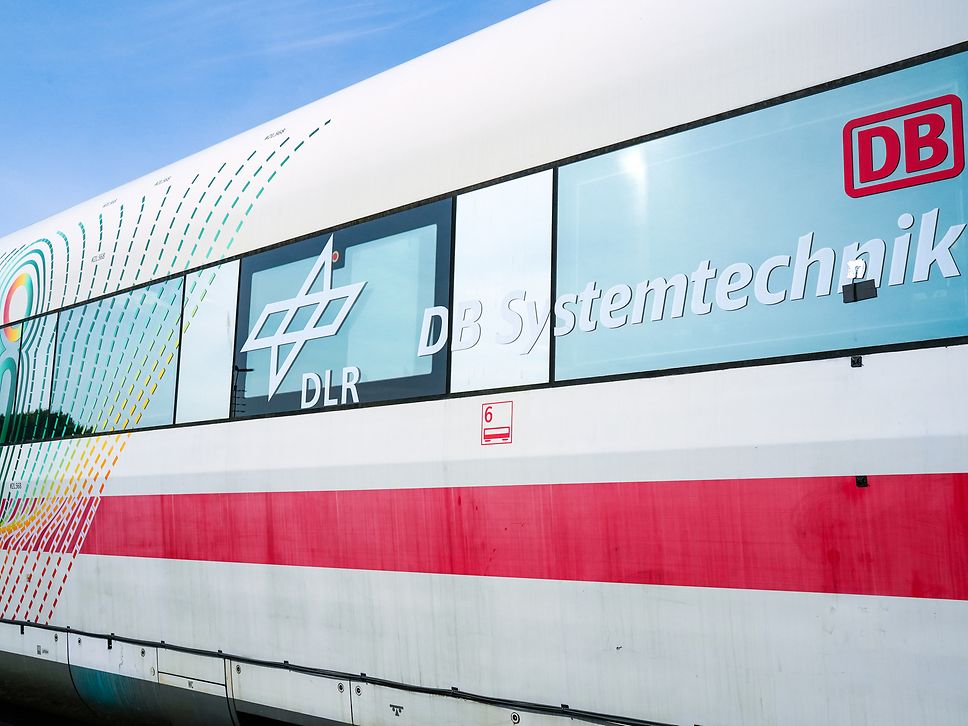 Exterior view of the DIRK for innovations in passenger comfort and climate control, featuring DB and DLR logos 